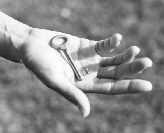 Open palm holding a key